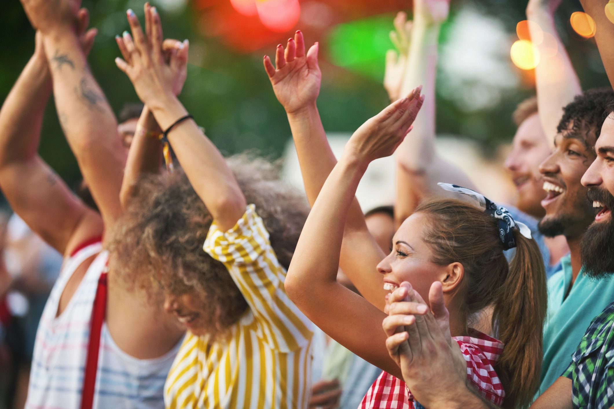 Friends dancing at an outdoor concert