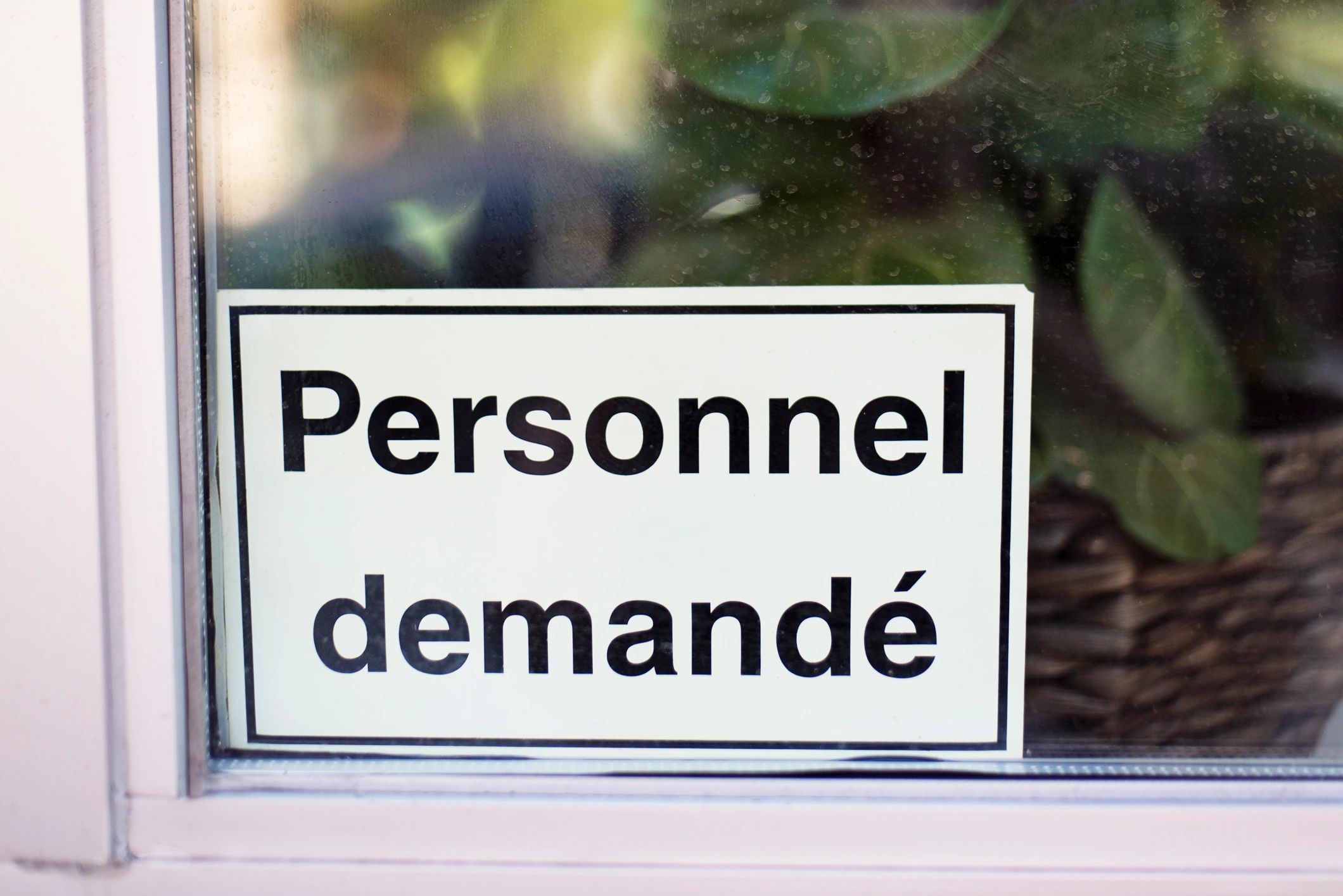 Help wanted sign in a storefront window