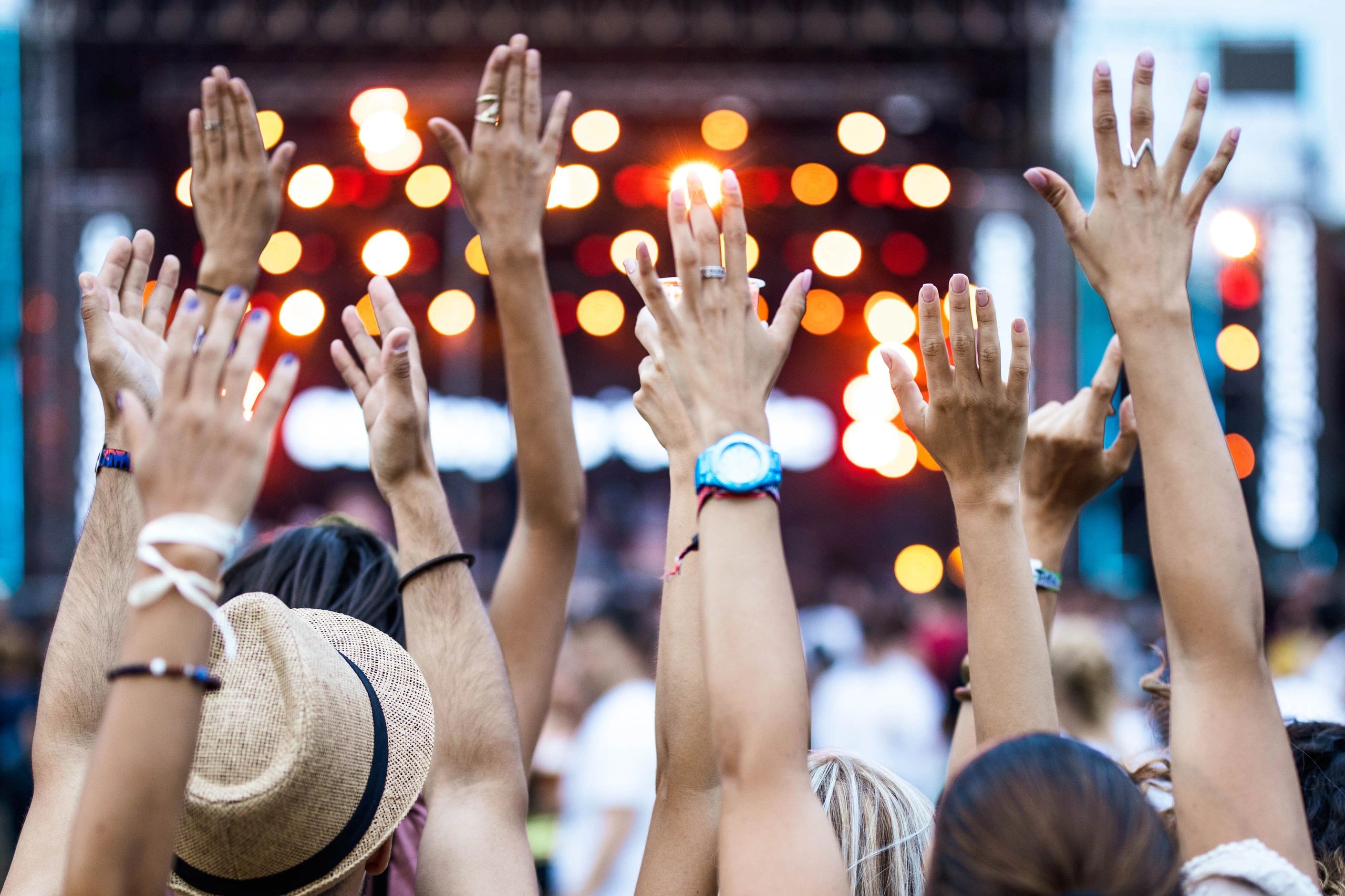 Hands raised at a festival crowd scene